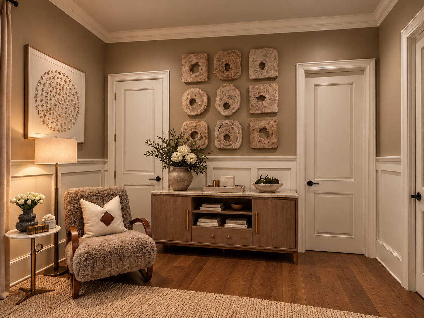 A bedroom sitting area with a textured lounge chair, wood console and dimensional wall art